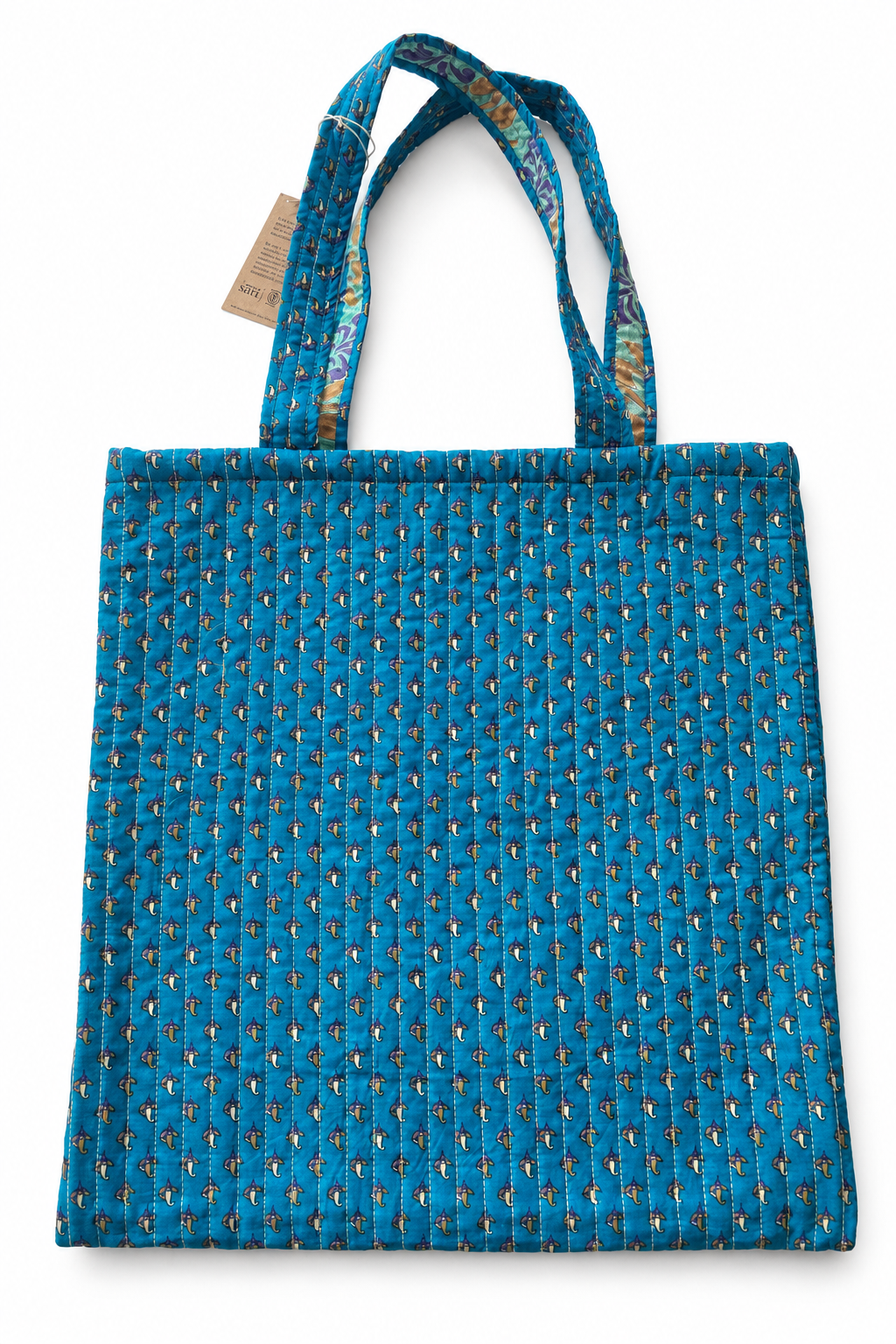 Sac cabas en sari indien recyclé bleu turquoise à petits motifs ocre, avec deux anses.
