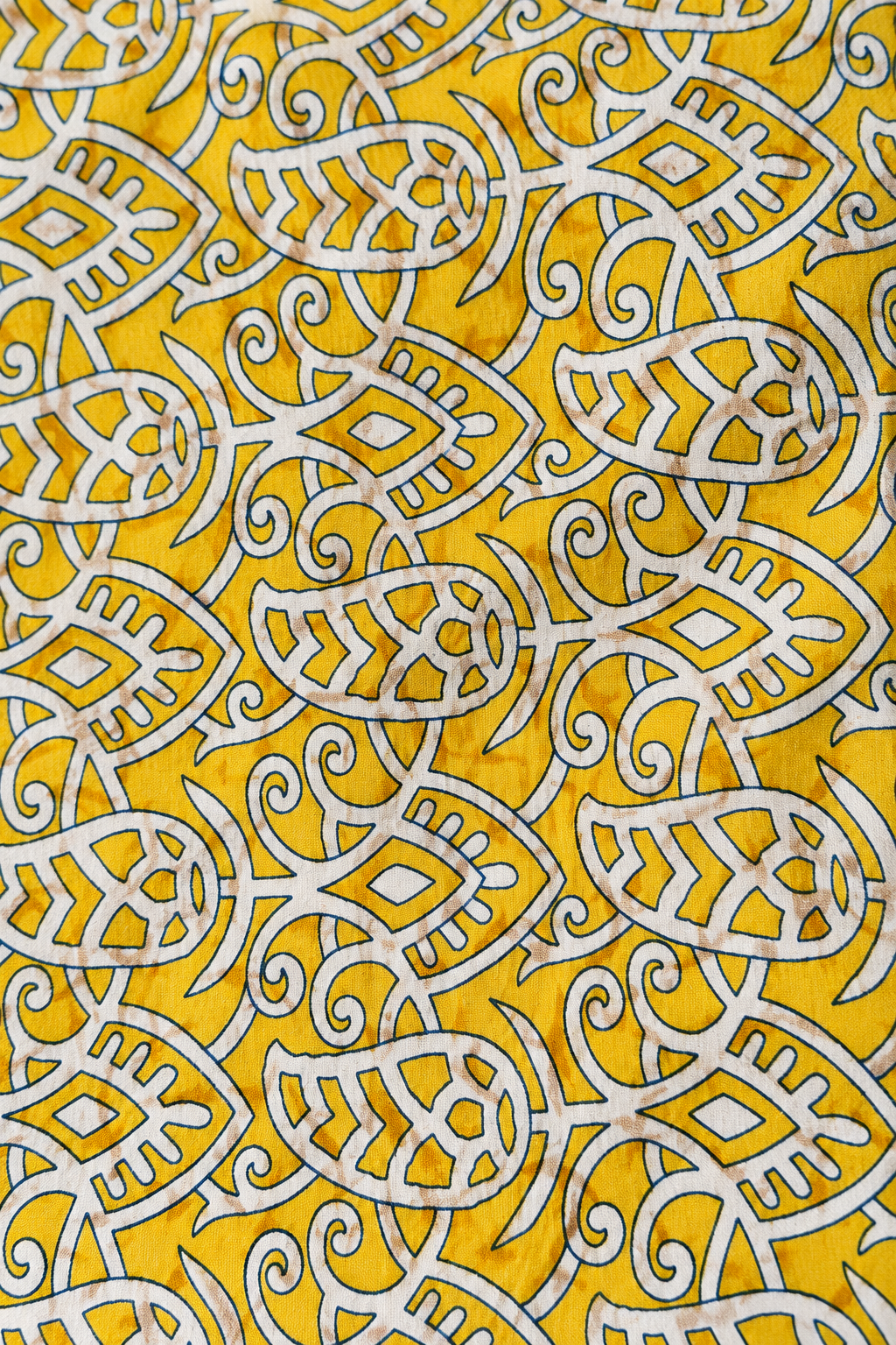 Détail du tissu jaune et blanc à motifs du sac de yoga en sari indien recyclé.